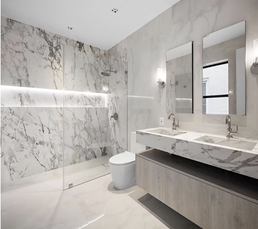 Marble bathroom with double vanity, twin mirrors and walk in shower
