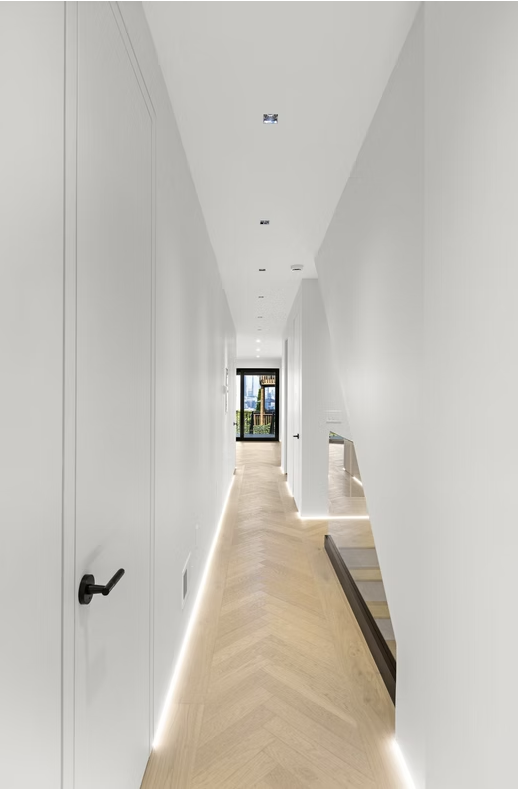 Herringbone hallway looking through to the glazed rear doors and stair