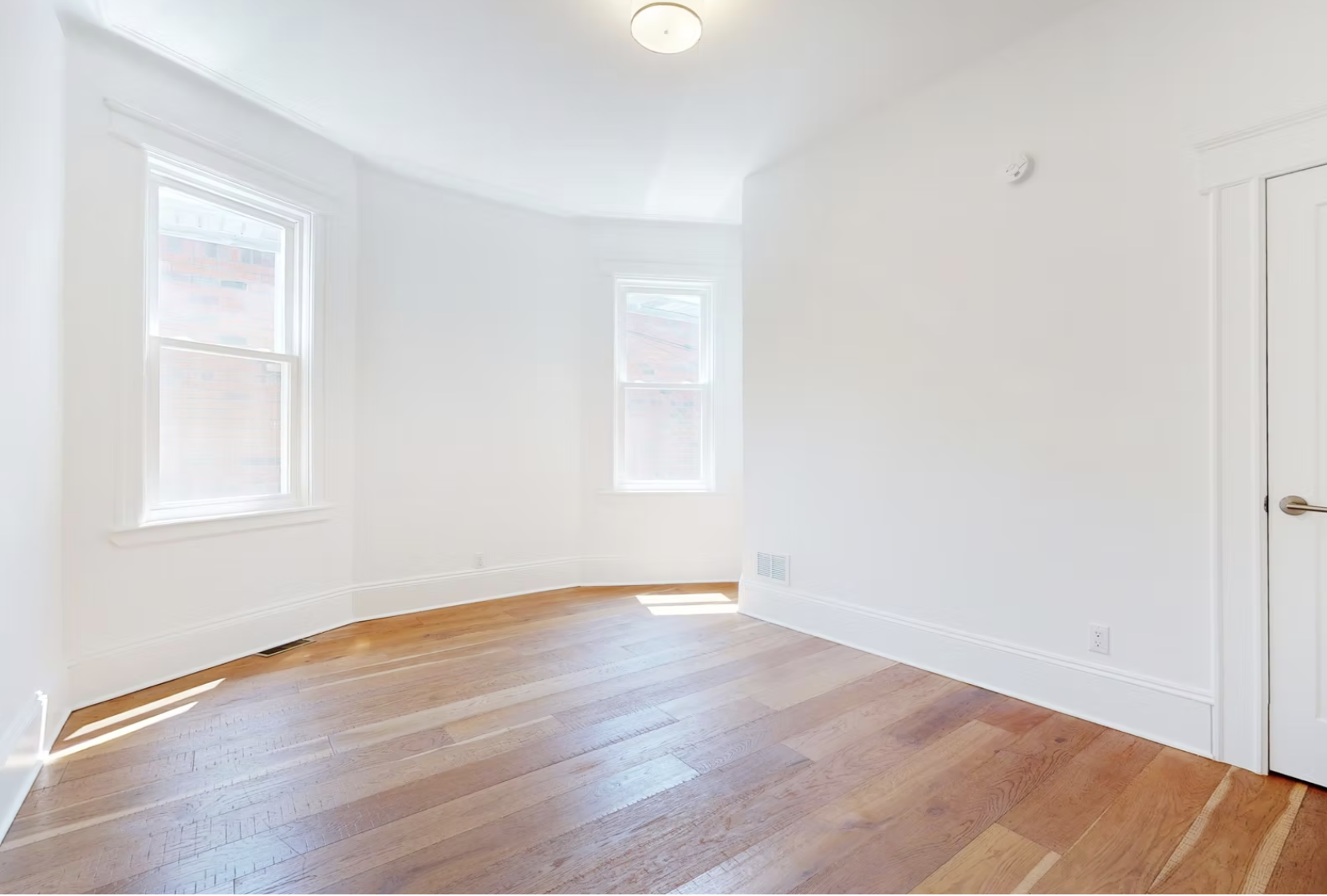 Bedroom with bay window, new plaster and restored timber floor