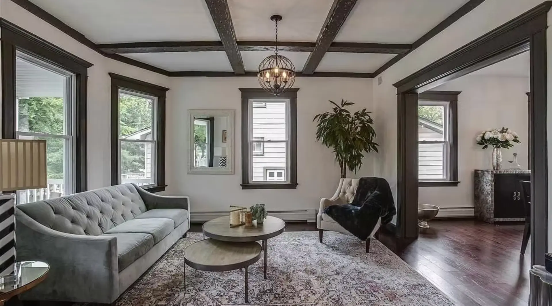 Dining room with beaded chandelier and stone clad fireplace