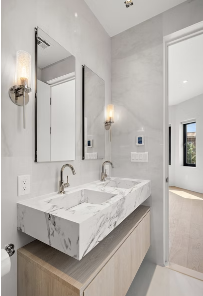 Book matched marble double vanity with oak joinery