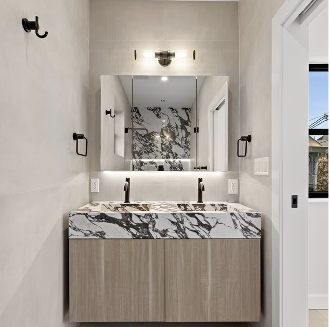 Twin marble basins with oak vanity unit