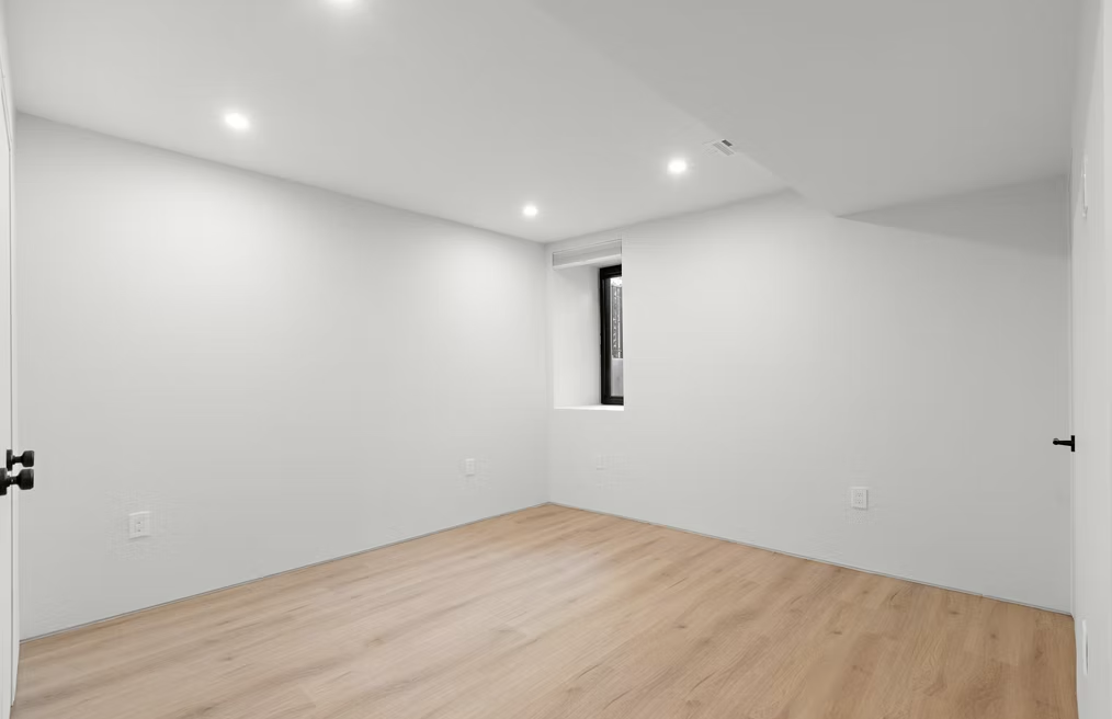 Bedroom with oak flooring and recessed lighting