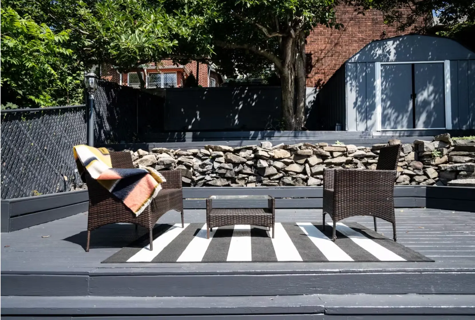 Rebuilt rear garden with decked terrace and stone walling