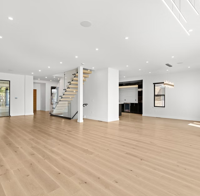 Wide open plan floor with oak stair and bar joinery beyond
