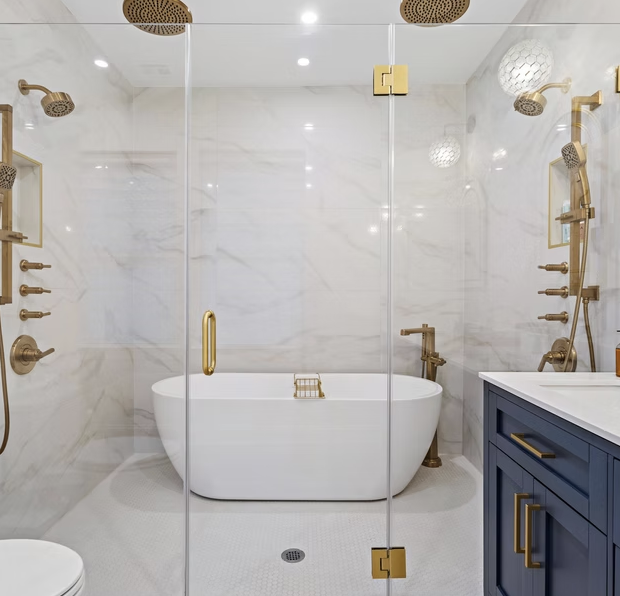 Marble wet room with freestanding bath and glazed shower enclosure