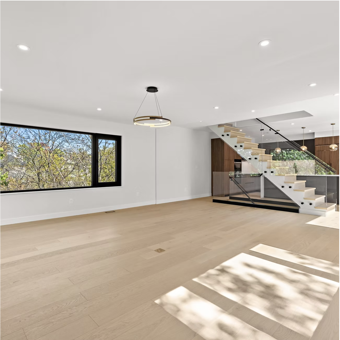 Open plan living floor with glass balustraded stair