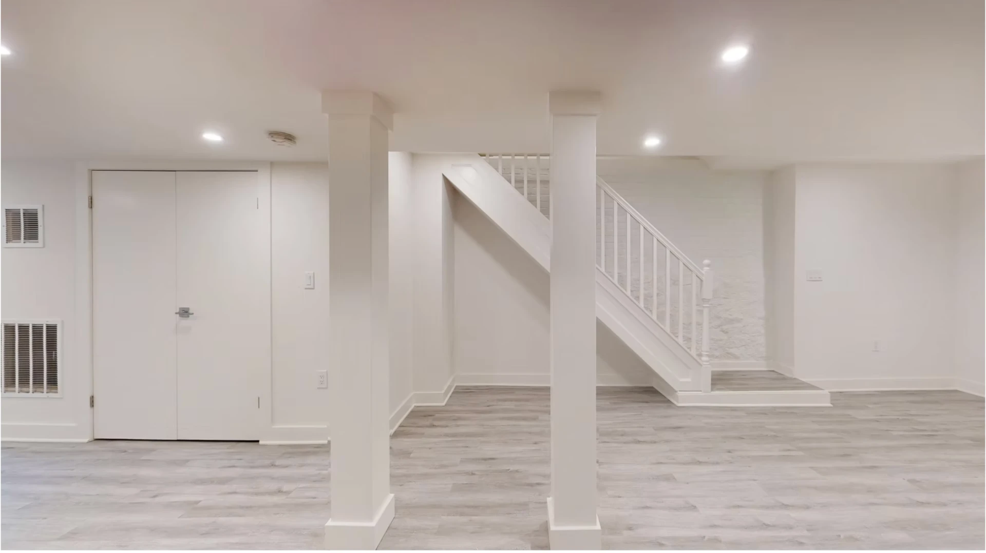Finished lower ground living space with new stair and pale flooring