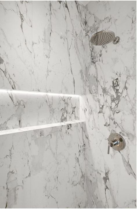 Marble walk in shower with backlit niche and rainfall head