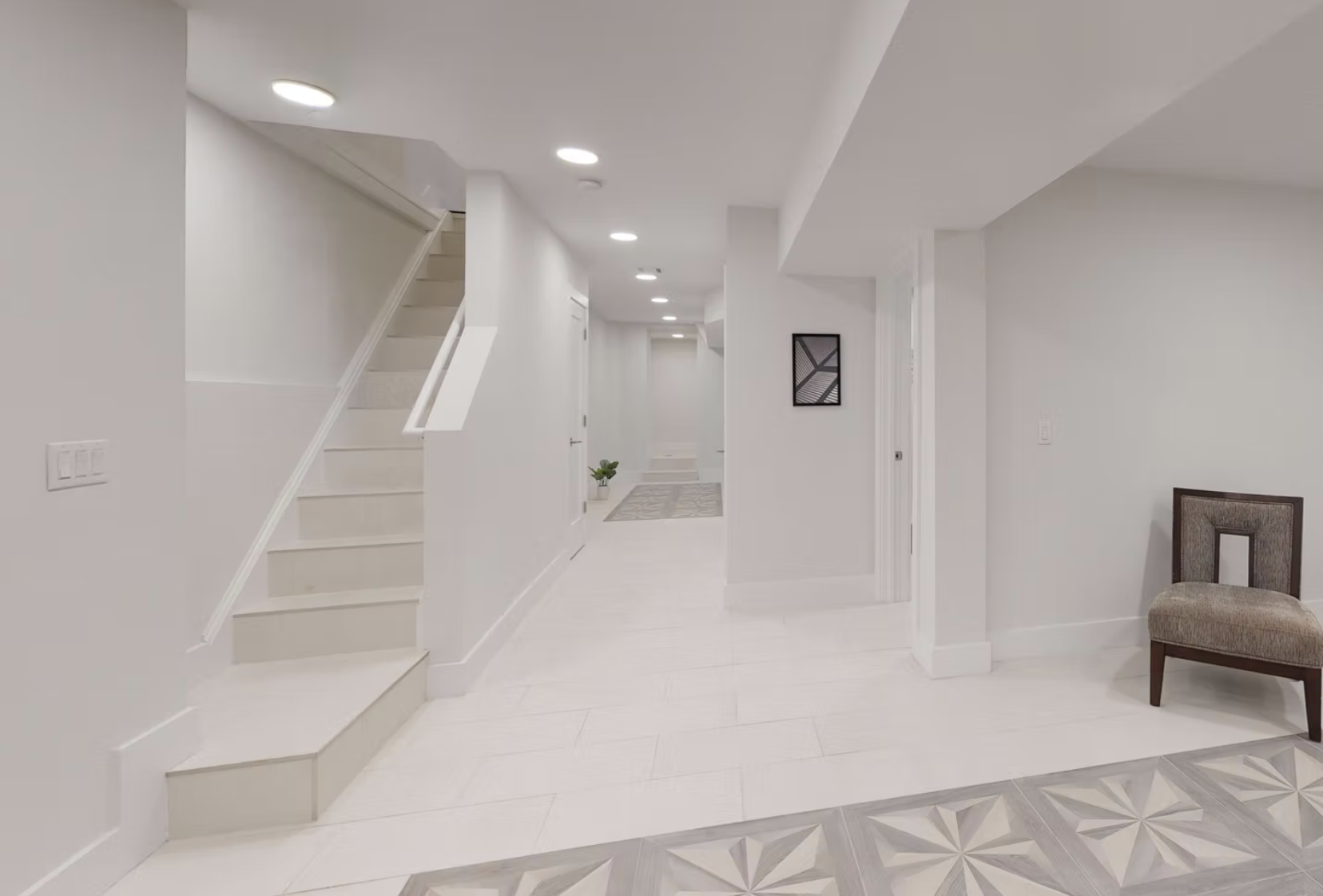 Lower ground hallway with stair, white tiled flooring and patterned inlay