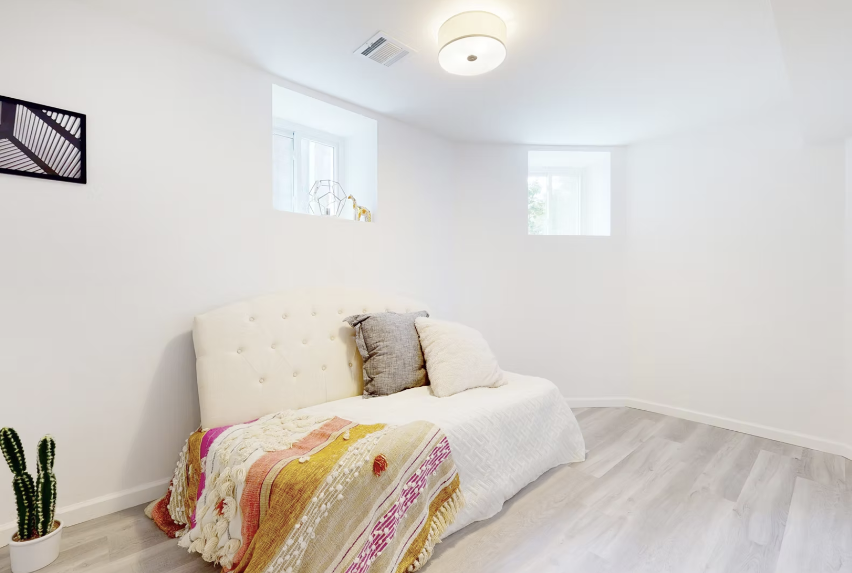 Lower ground bedroom with pale timber flooring and new lighting