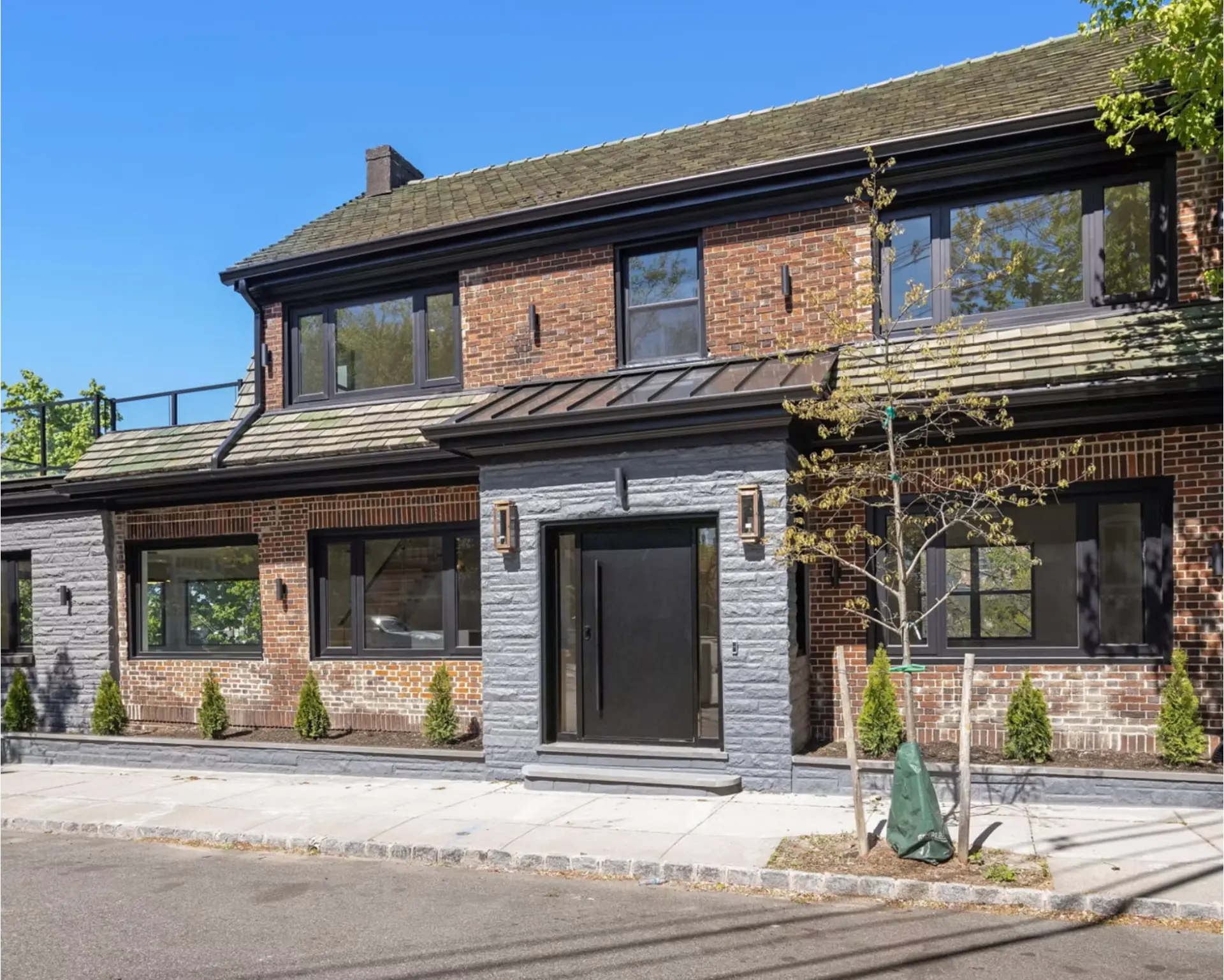 Restored brick and stone facade with black framed windows
