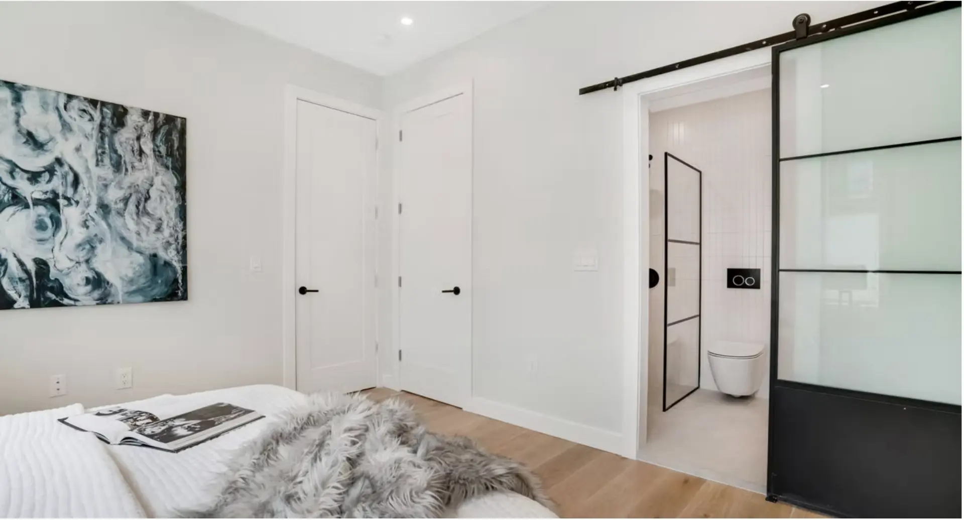 Bedroom with steel framed sliding door to the en suite