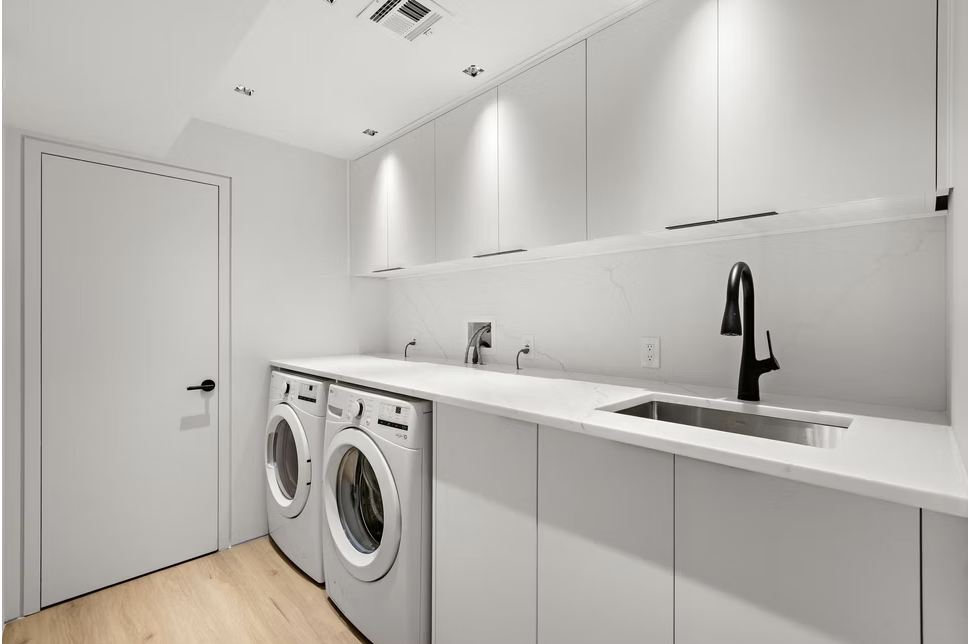 Utility room with white joinery and stone worktop
