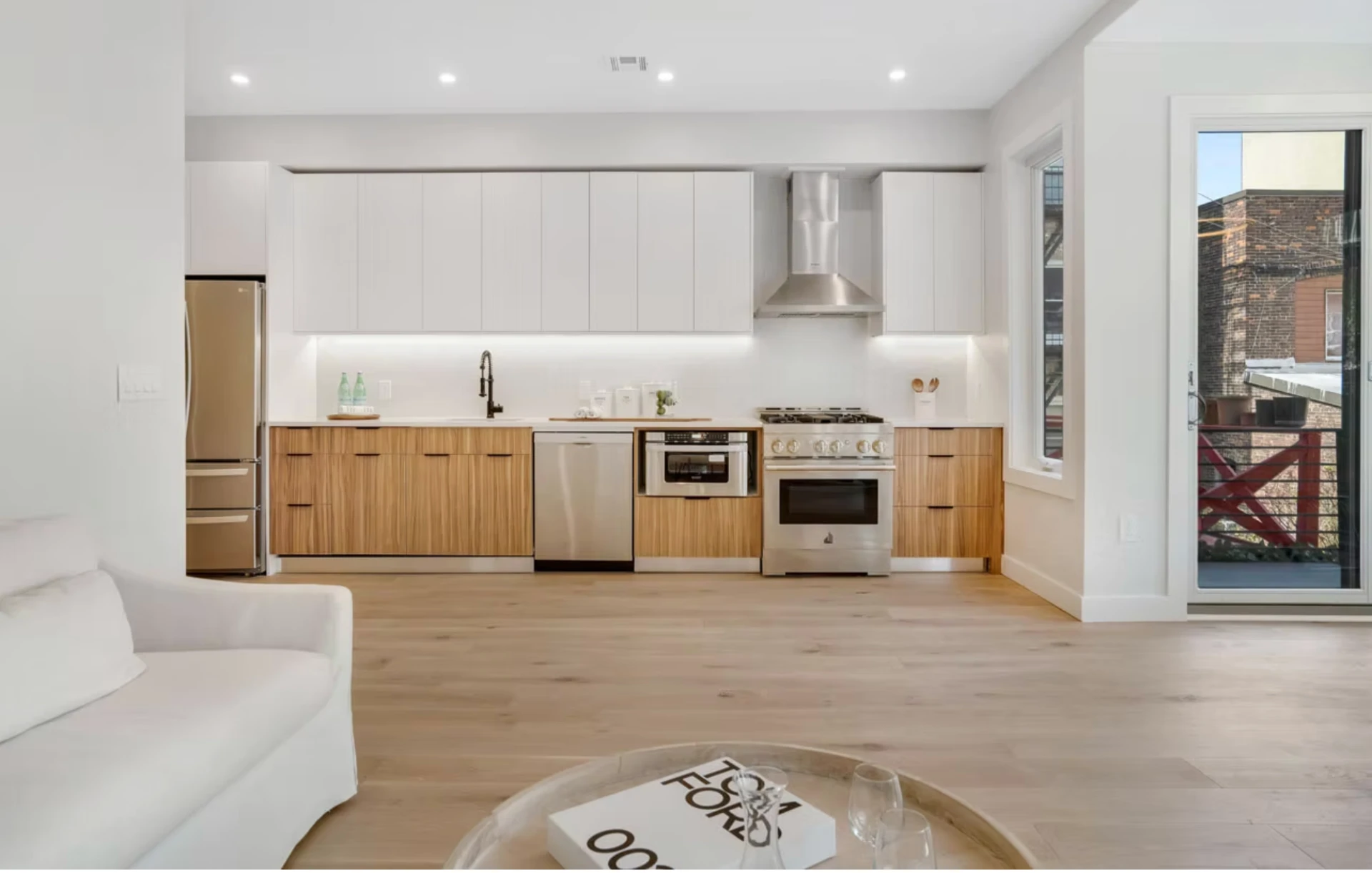 Contemporary kitchen with timber fronts and integrated appliances