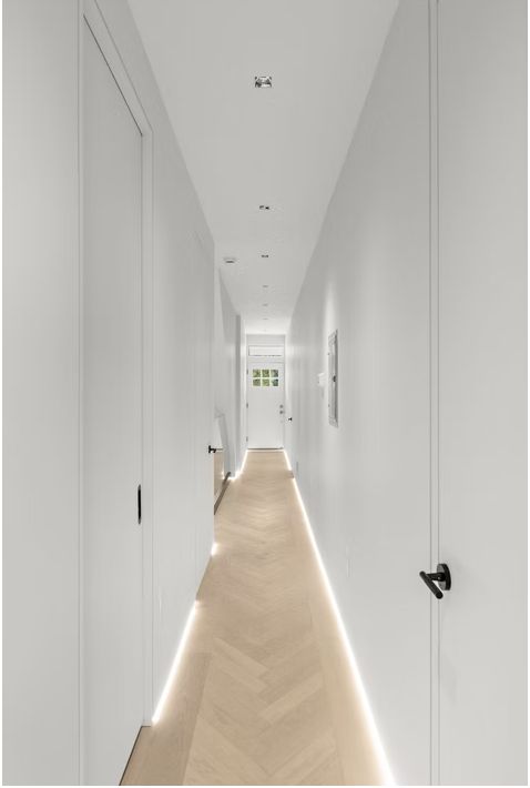 Herringbone corridor with continuous LED floor lighting