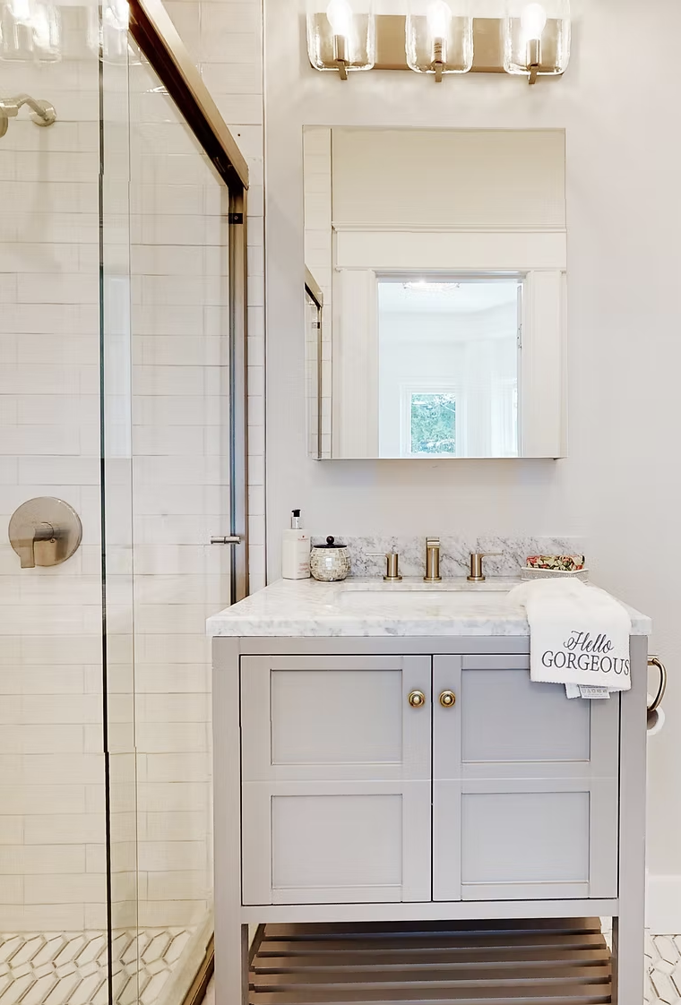 Shower room with marble vanity, brass fittings and glazed enclosure