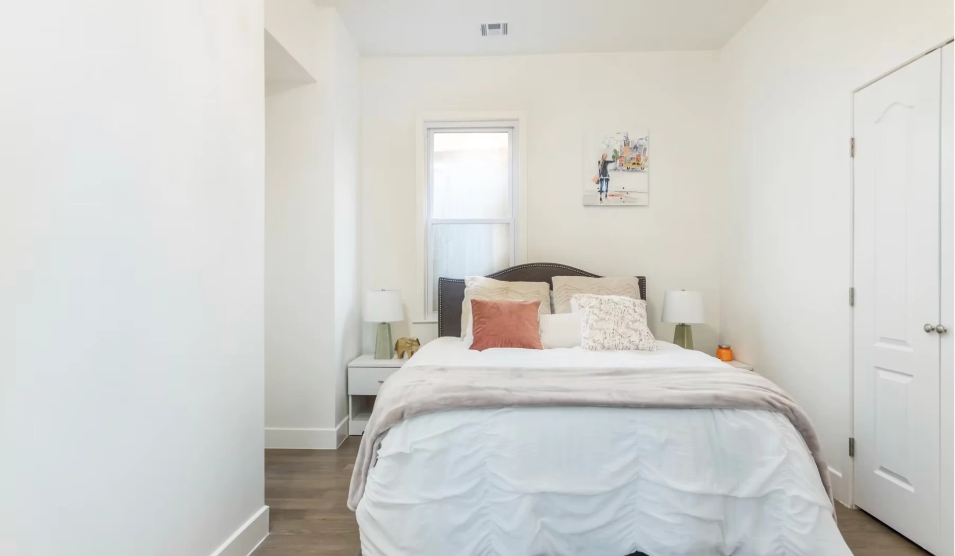 Guest bedroom with soft neutral finishes and fitted wardrobe