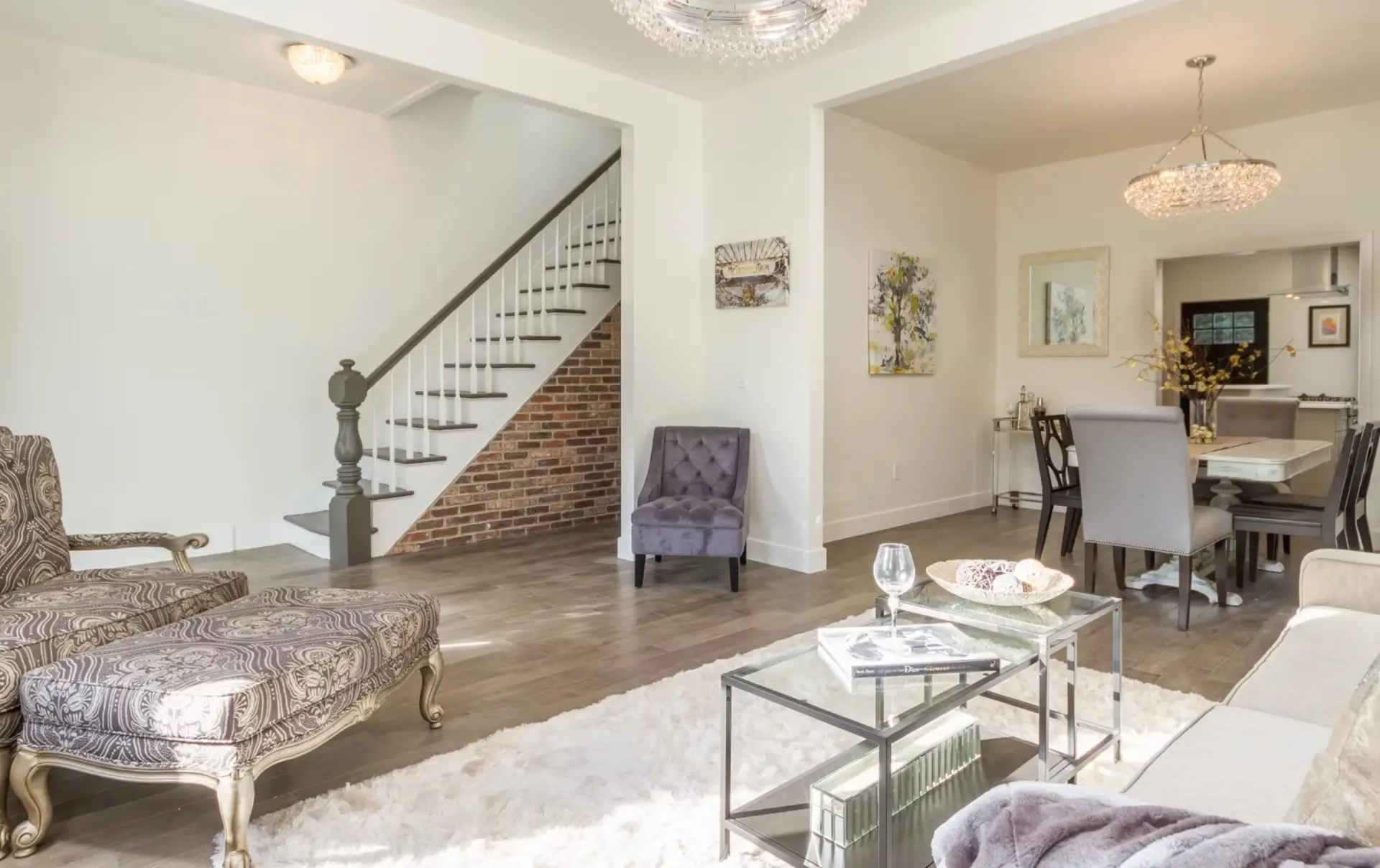 Open reception room with restored stair and exposed brick wall