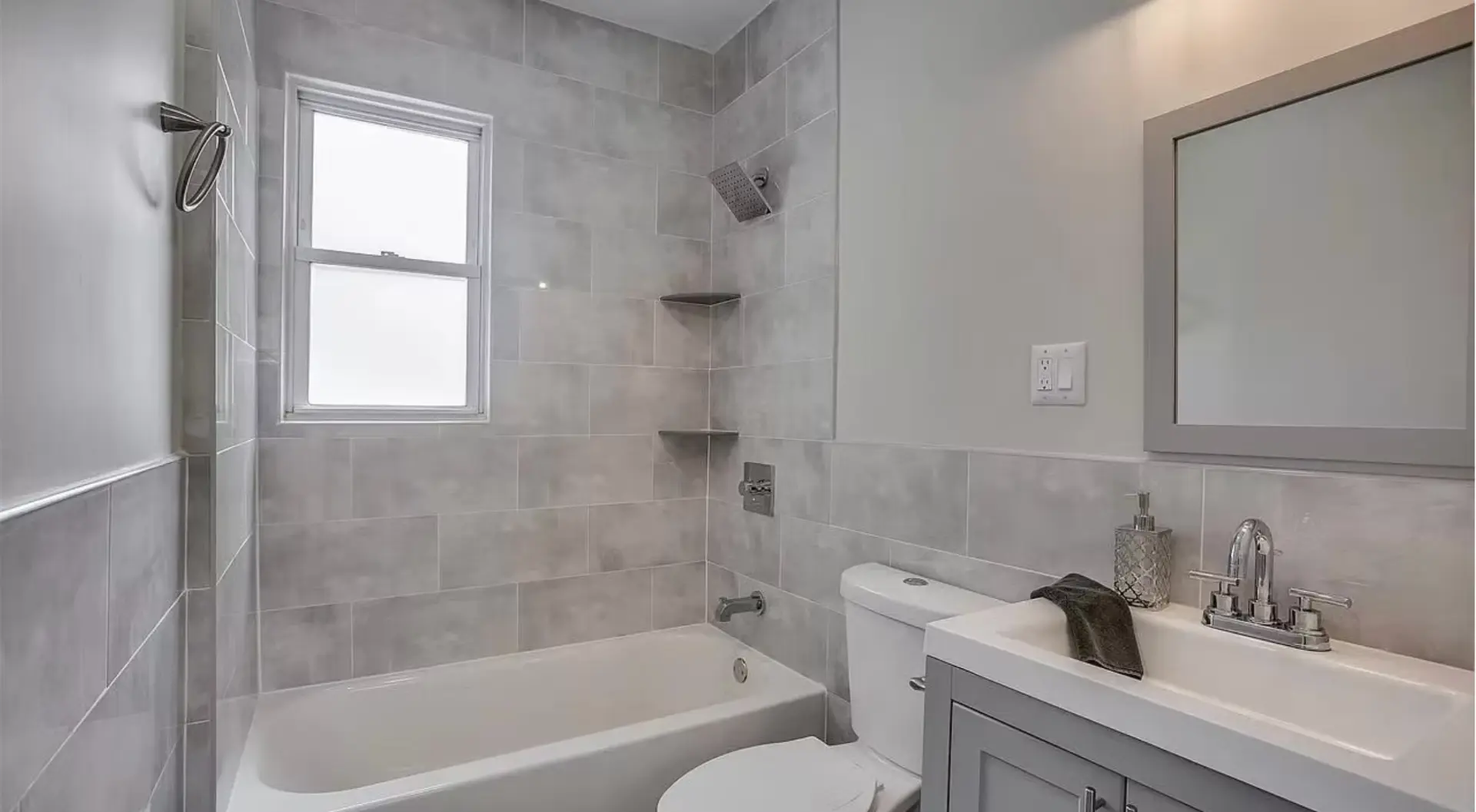 Family bathroom with stone tiling and fitted vanity