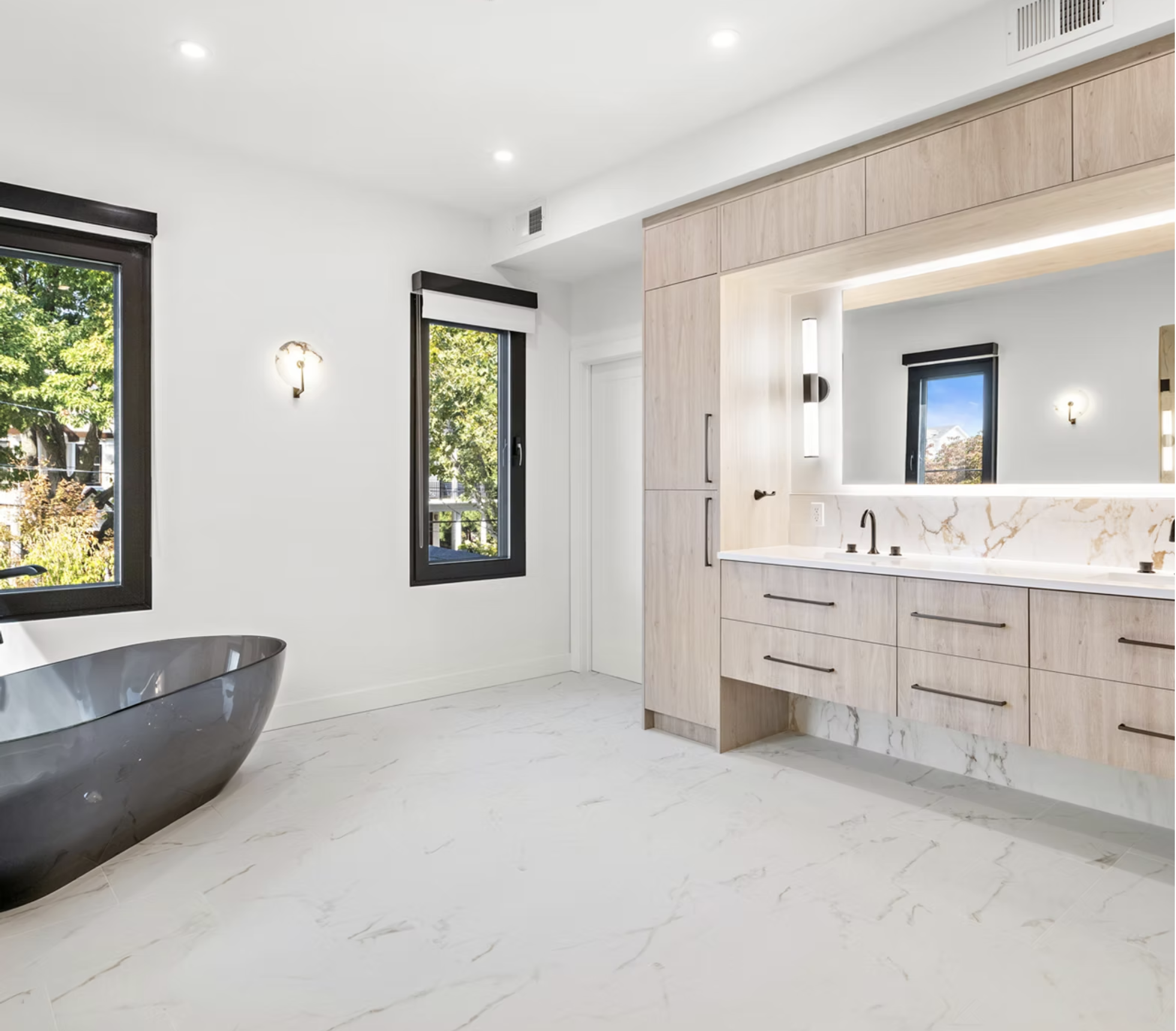 Principal bathroom with black stone bath and oak vanity run