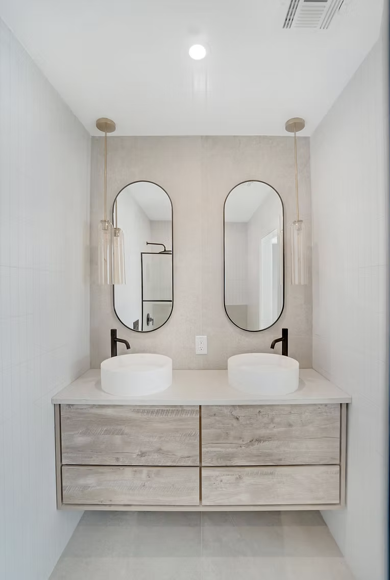 Twin oval mirrors above a timber double vanity