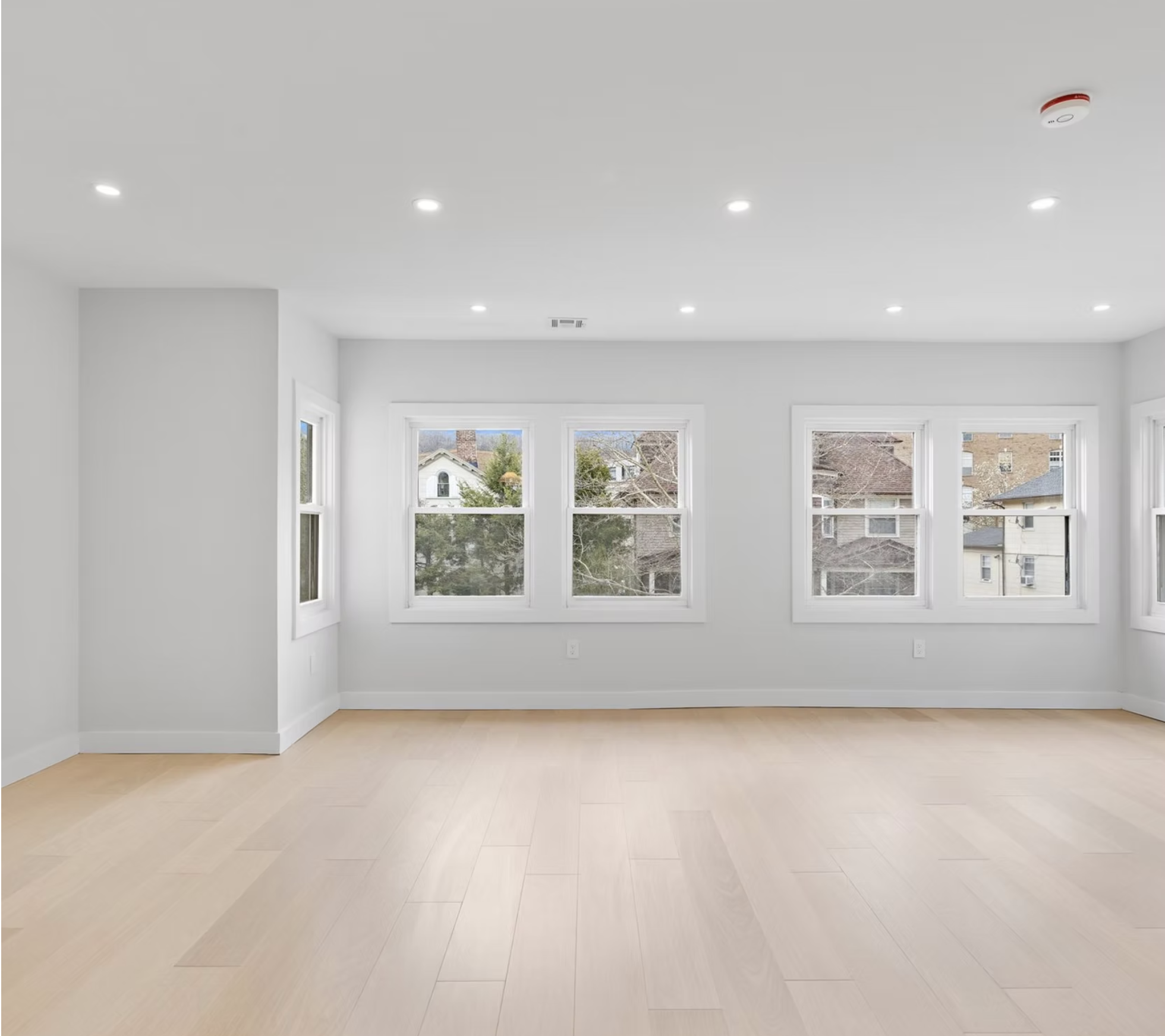Bright reception room with new windows and oak flooring