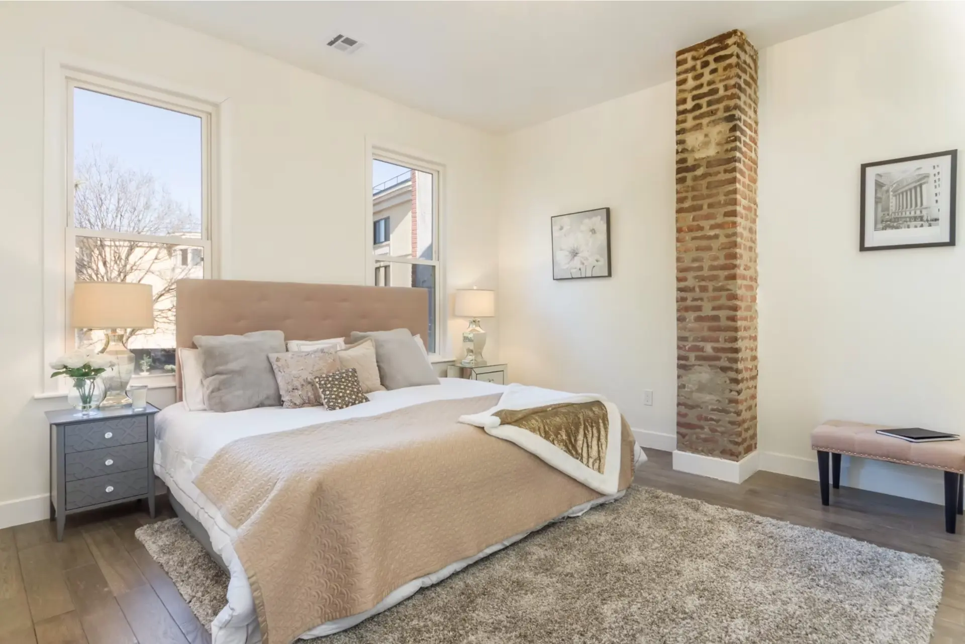Principal bedroom with exposed brick chimney breast