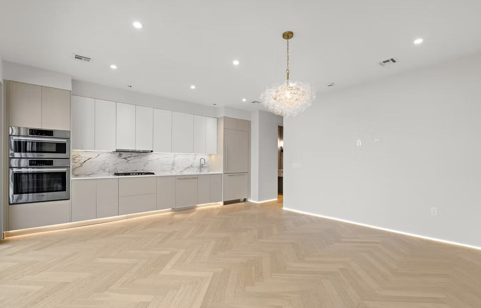 Open plan kitchen and dining space with herringbone oak flooring