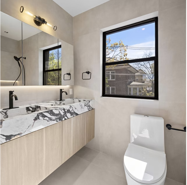 Guest bathroom with marble vanity and black fittings