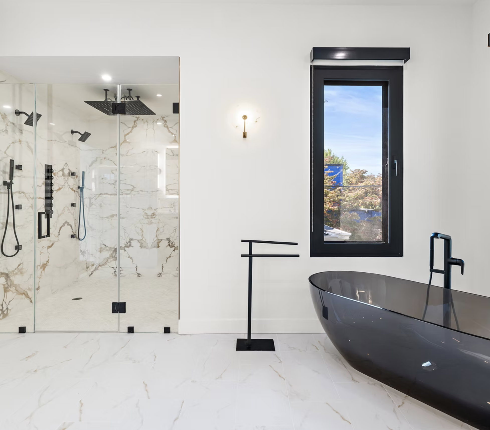 Marble shower room with black fittings and freestanding bath