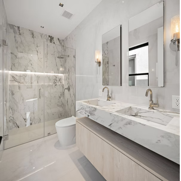 Marble shower room with twin basins and polished nickel fittings
