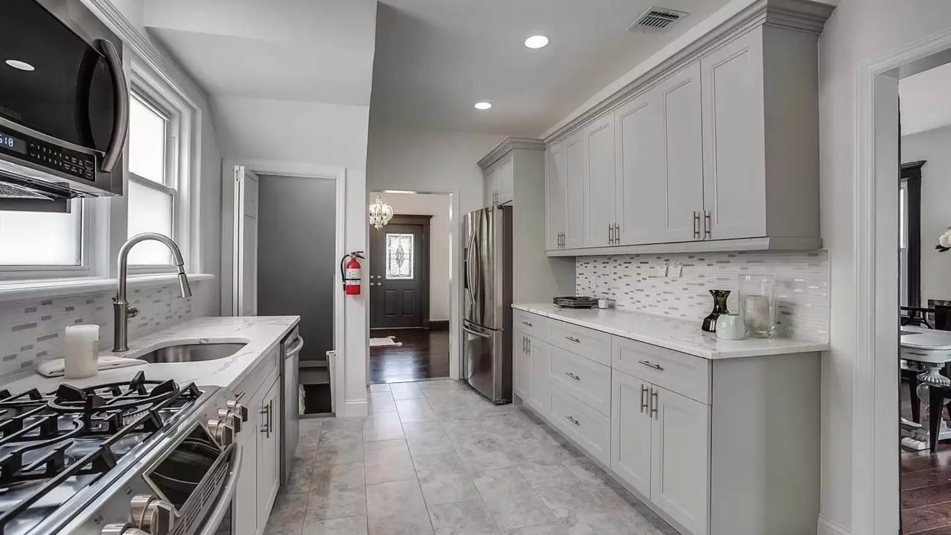 Galley kitchen with shaker cabinetry and quartz worktops