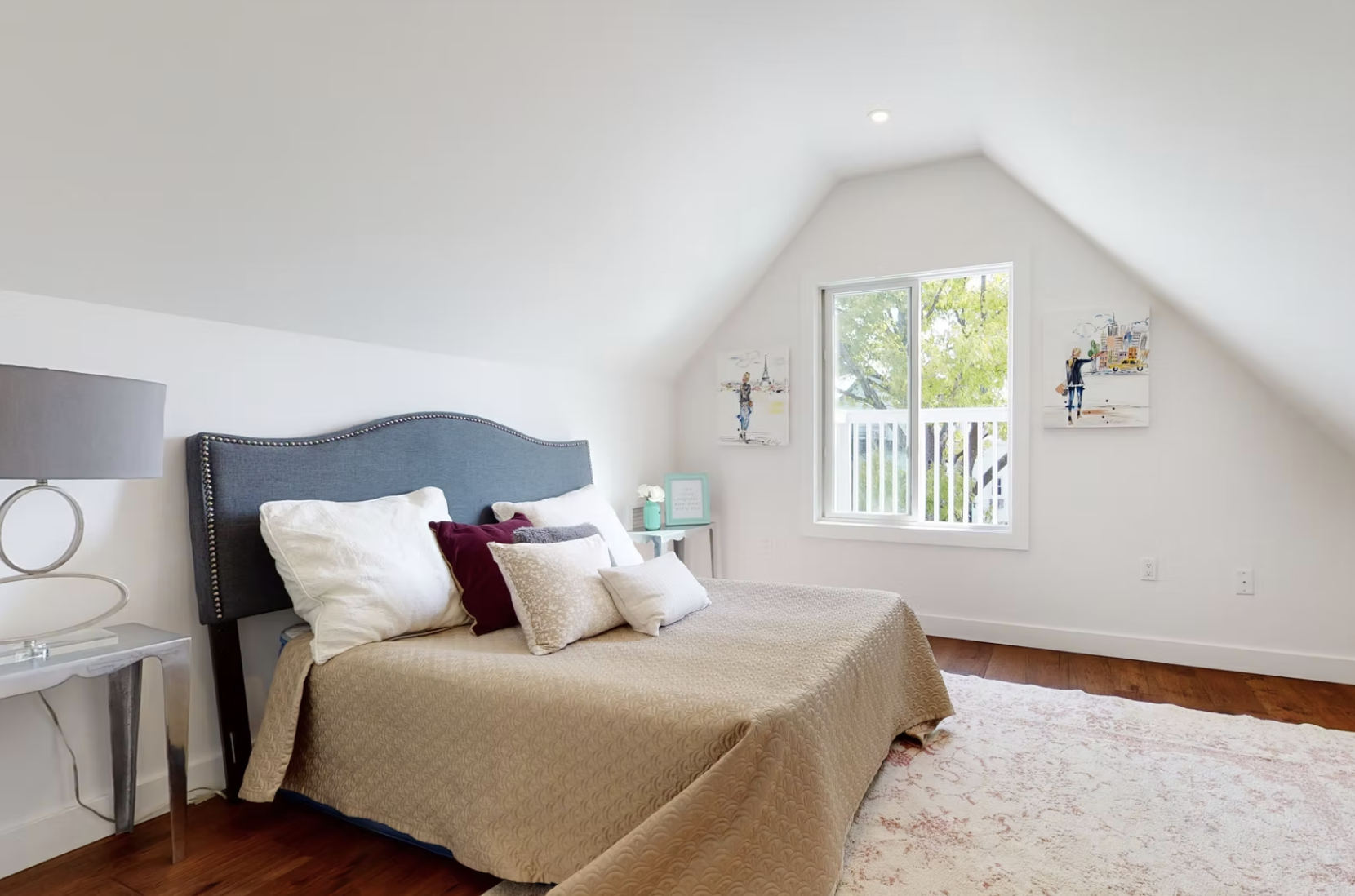 Loft bedroom with pitched ceiling, window seat and hardwood flooring