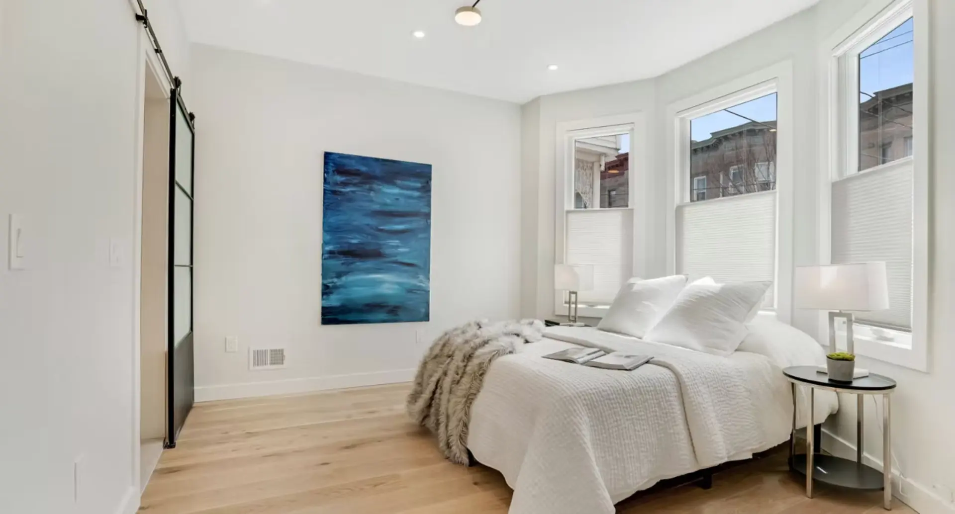 Bedroom with bay windows and sliding glass door