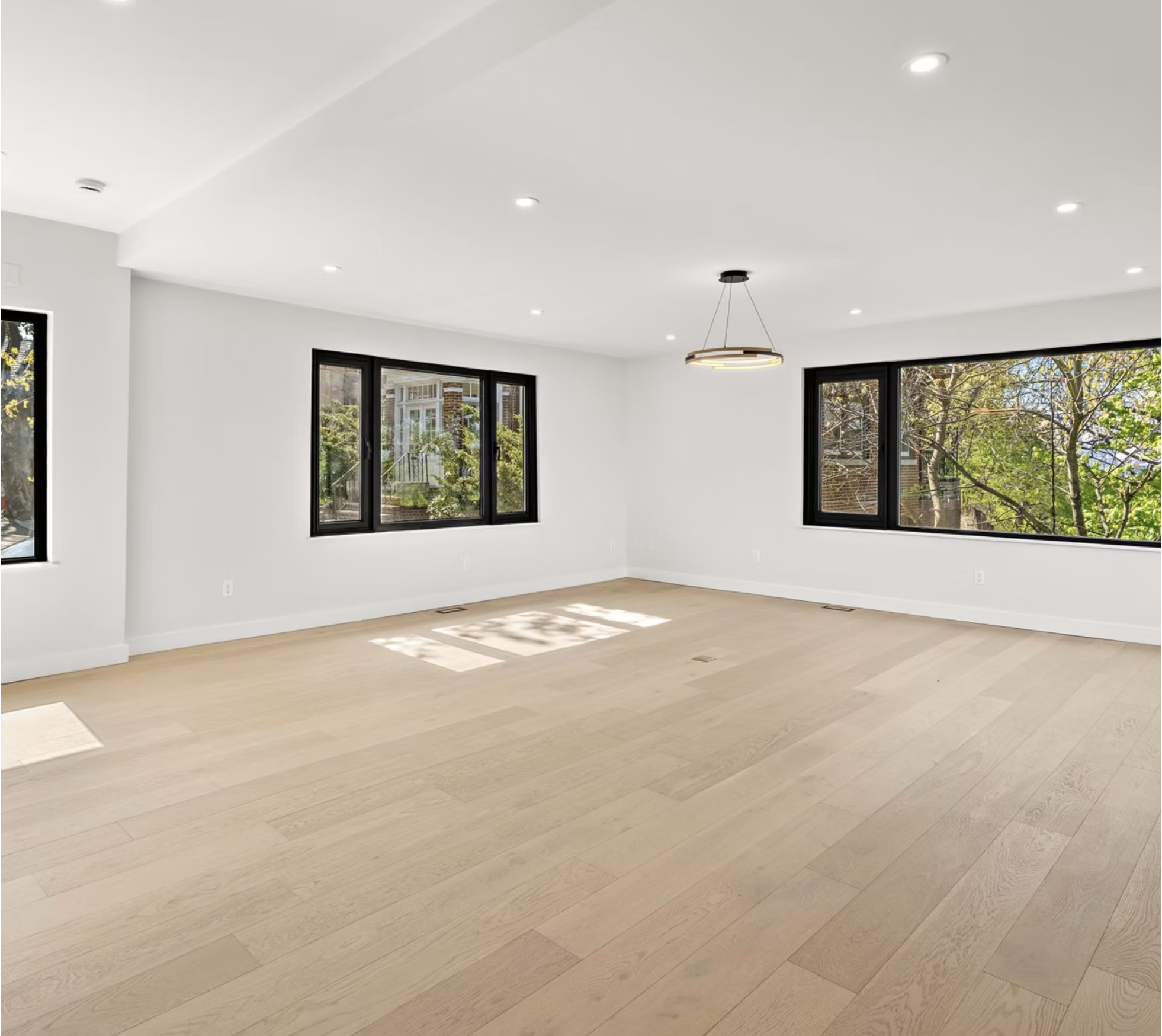 Bright reception room with wide black framed windows