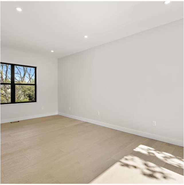 Bright bedroom with pale oak flooring