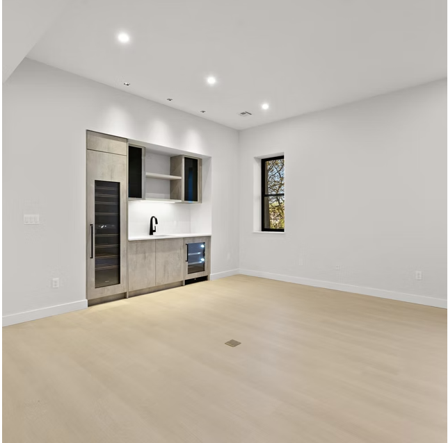 Reception room with built in bar and oak flooring