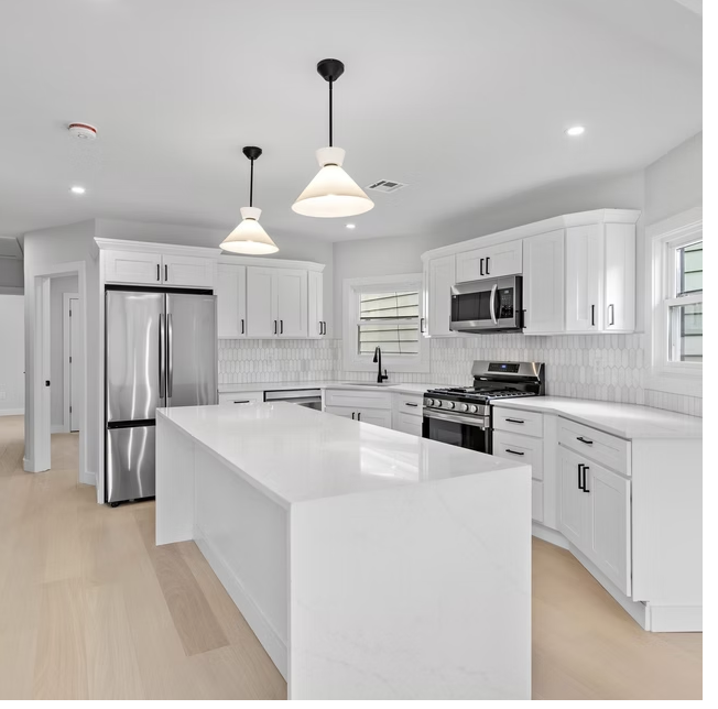 Bespoke kitchen with stone island and pendant lighting